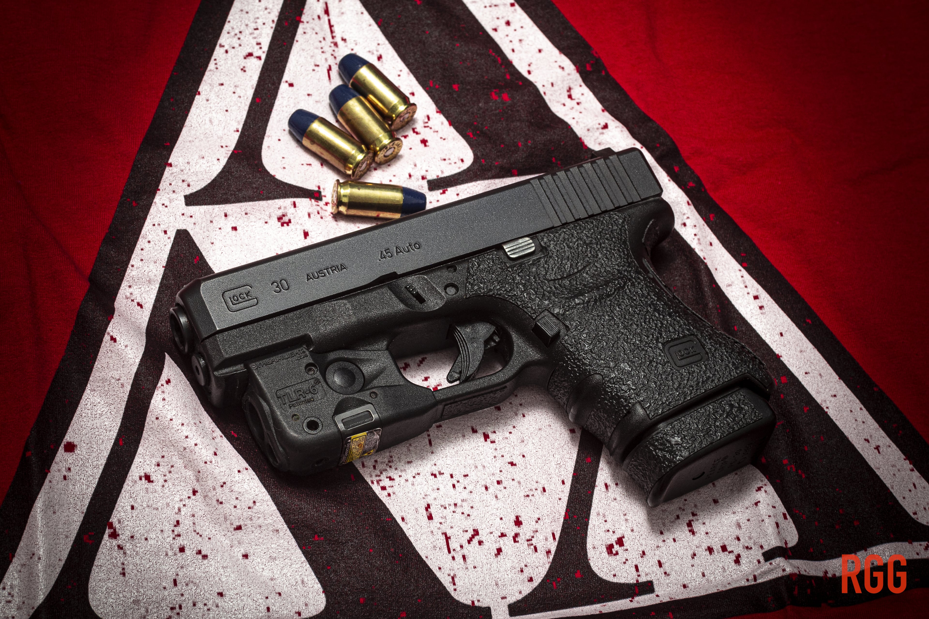 A GLOCK 30 .45 ACP pistol atop a logo of a well-known fraternity.